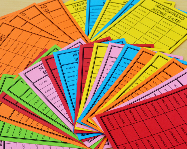 Fanned out score cards in a variety of colours: red, orange, green, yellow, pink and blue.  All are titled 